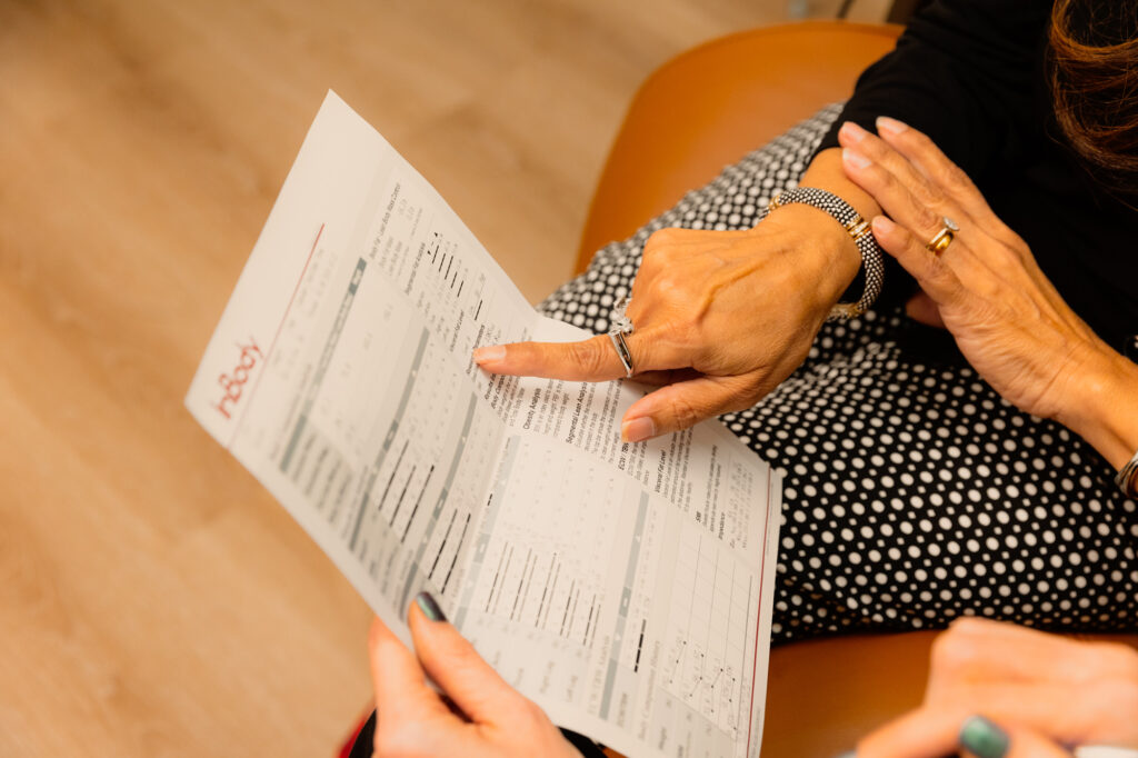 A patient reads the results of her InBody scan with a doctor to plan her peptides for fat loss in Atlanta.